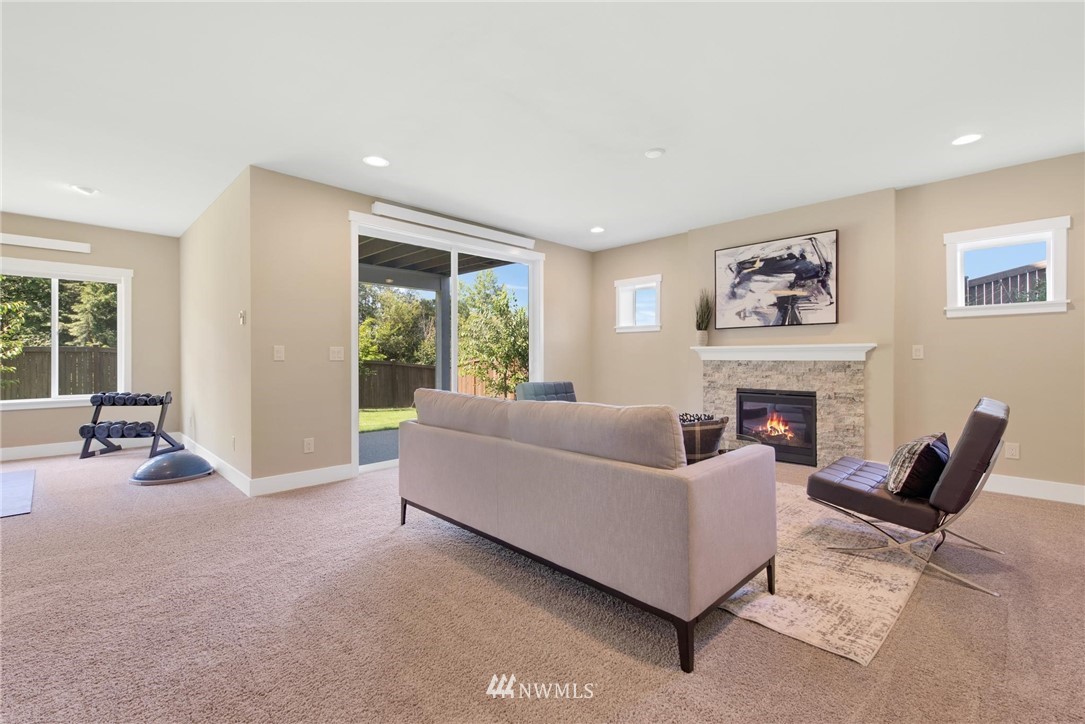 27418 Northeast 152nd Court Duvall, WA 98019 - Photo 27 of 40 a living room with furniture and a fireplace