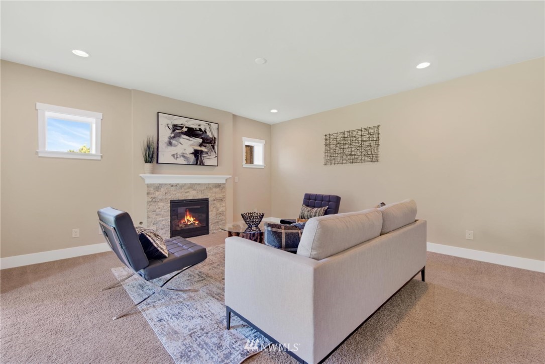 27418 Northeast 152nd Court Duvall, WA 98019 - Photo 28 of 40 a living room with furniture and a fireplace