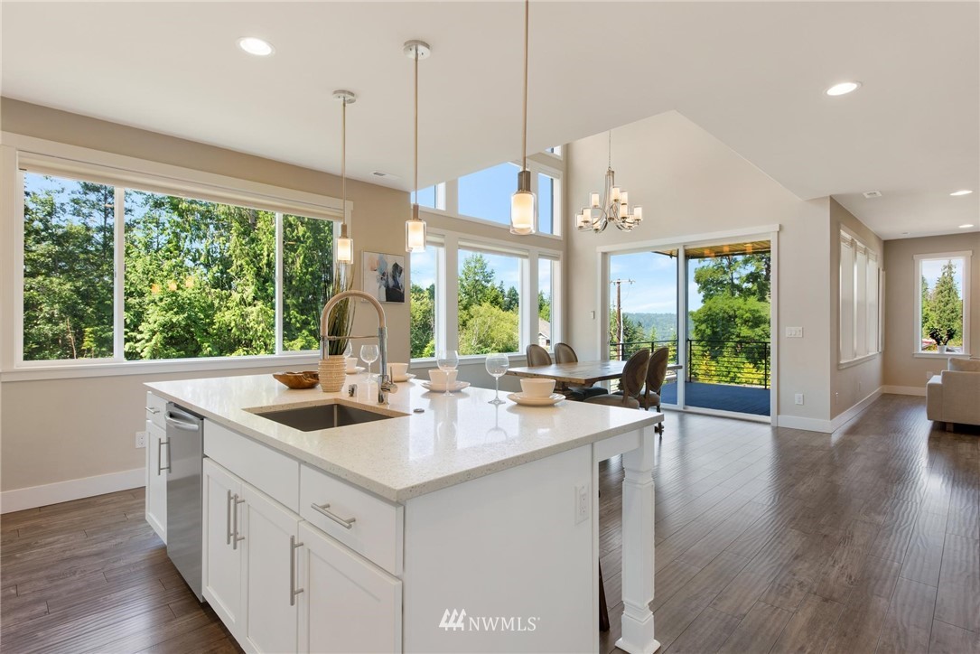 27418 Northeast 152nd Court Duvall, WA 98019 - Photo 6 of 40 a kitchen with a sink window and wooden floor