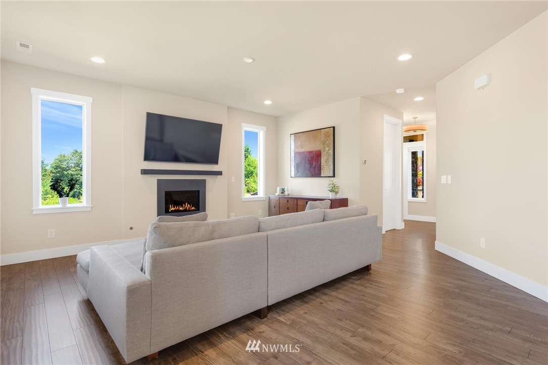 27418 Northeast 152nd Court Duvall, WA 98019 - Photo 9 of 40 a living room with furniture a fireplace and a flat screen tv