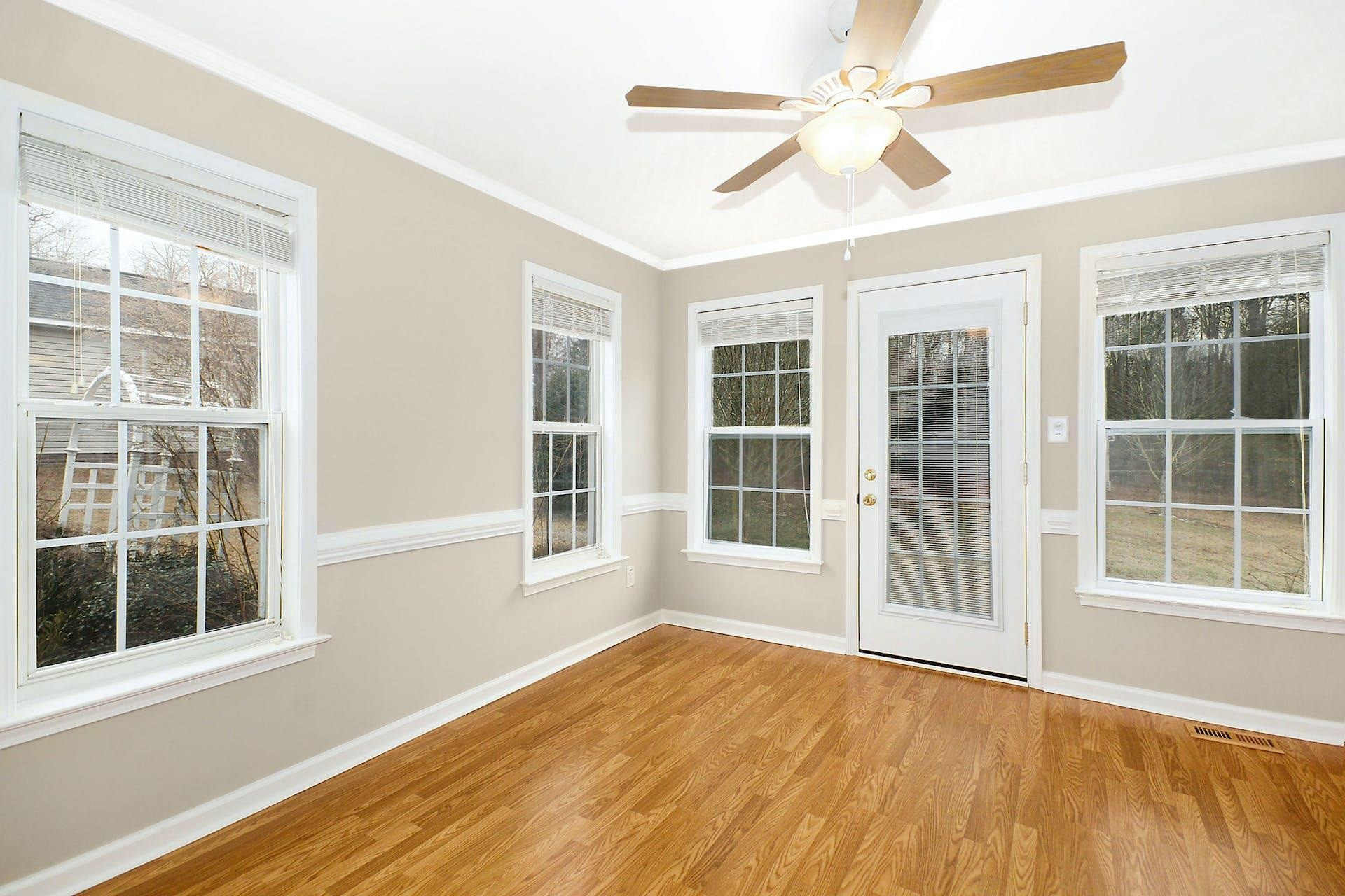 143 Susan Drive Garner, NC 27529 - Photo 11 of 27 an empty room with wooden floor and windows