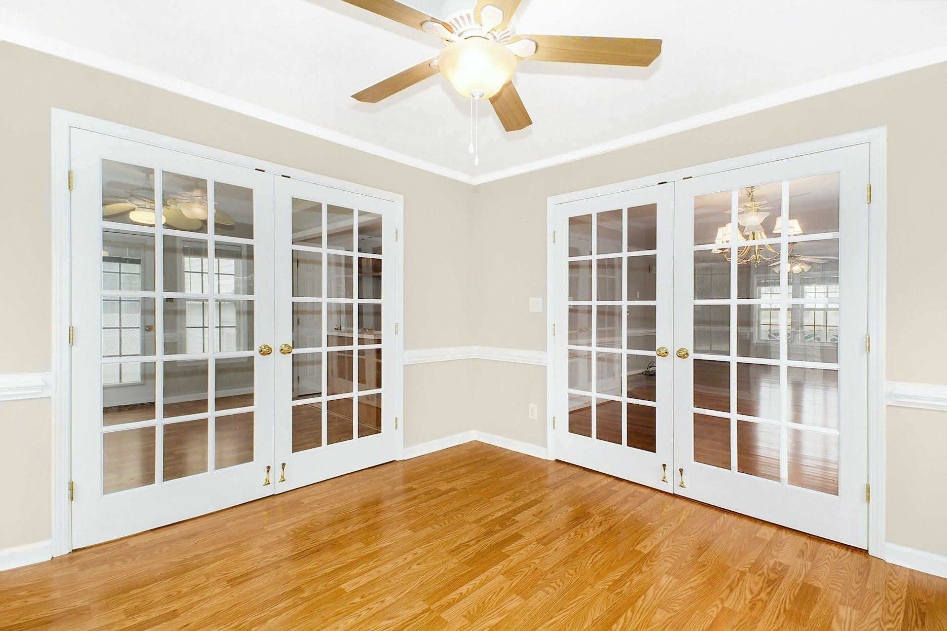 143 Susan Drive Garner, NC 27529 - Photo 12 of 27 a view of an empty room with a window and wooden floor