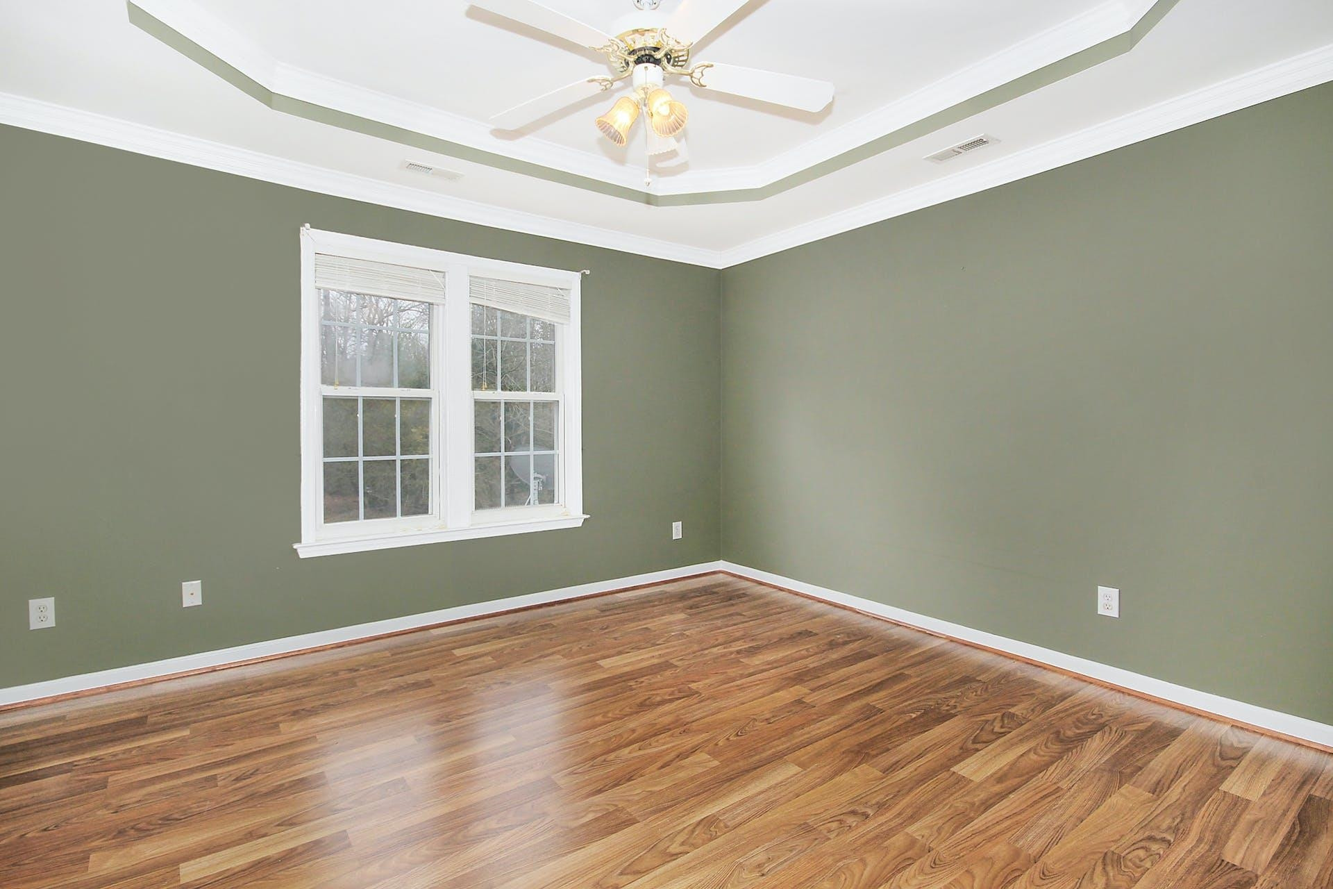 143 Susan Drive Garner, NC 27529 - Photo 14 of 27 a view of an empty room with wooden floor and a window