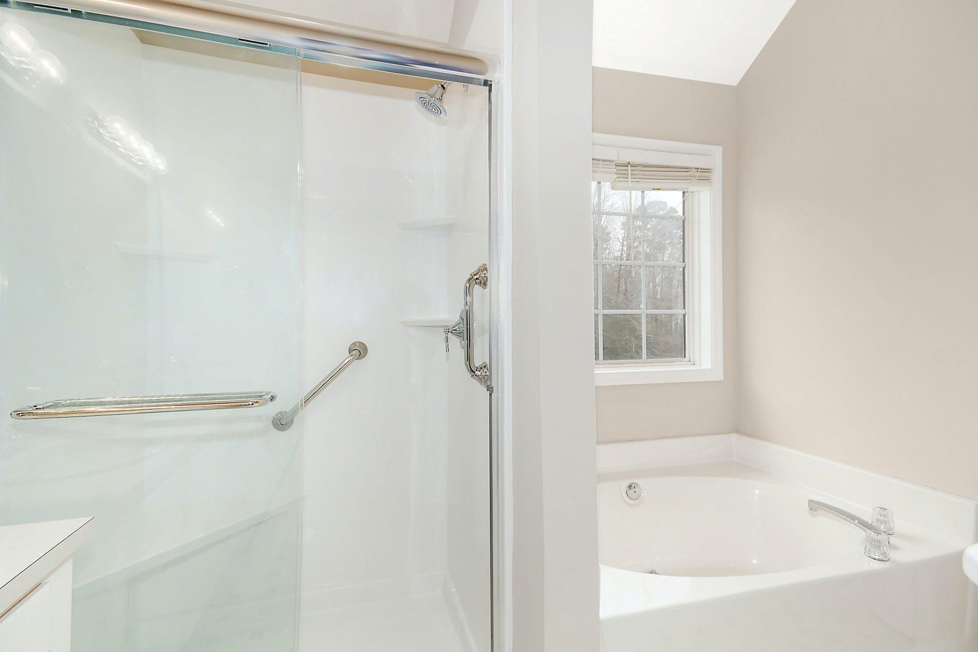143 Susan Drive Garner, NC 27529 - Photo 17 of 27 a bathroom with a shower and a window
