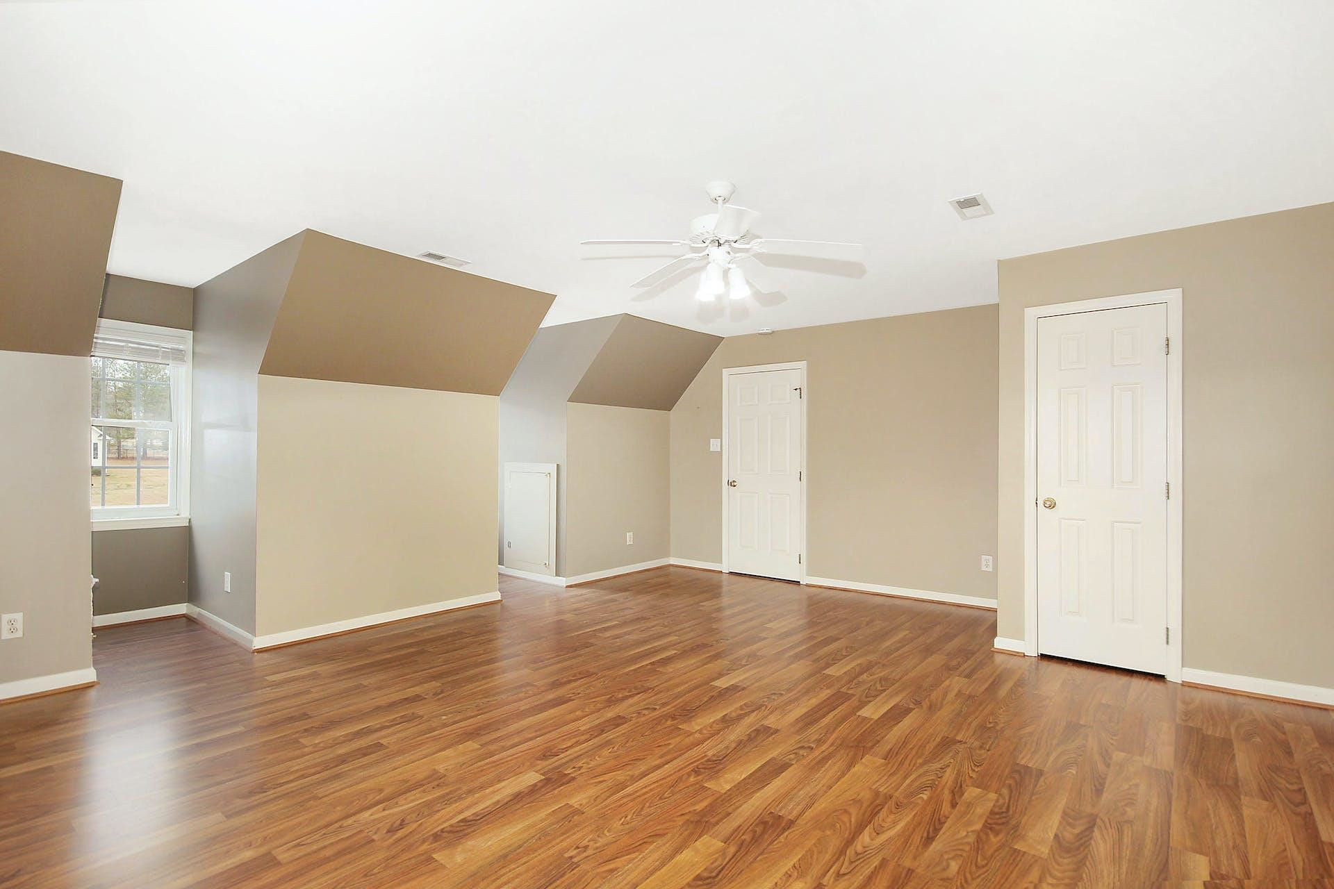 143 Susan Drive Garner, NC 27529 - Photo 22 of 27 an empty room with wooden floor and chandelier fan