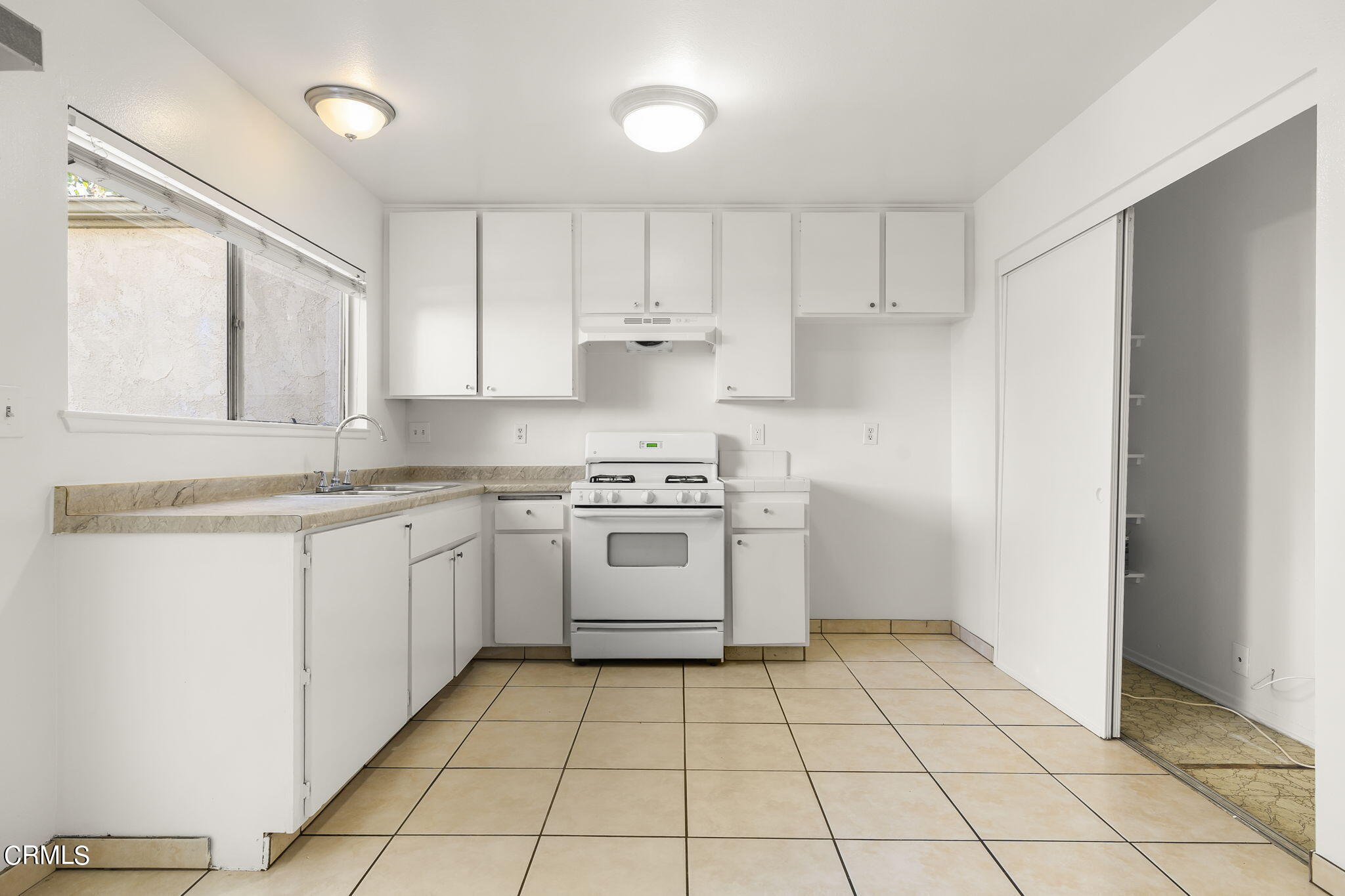 1440 Friedrich Lane, Unit C Oxnard, CA 93033 - Photo 11 of 30 a kitchen with a stove sink and cabinets