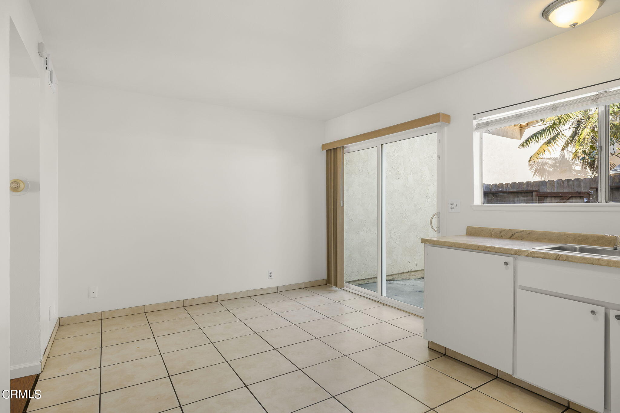 1440 Friedrich Lane, Unit C Oxnard, CA 93033 - Photo 13 of 30 a view of an empty room with a window and a kitchen