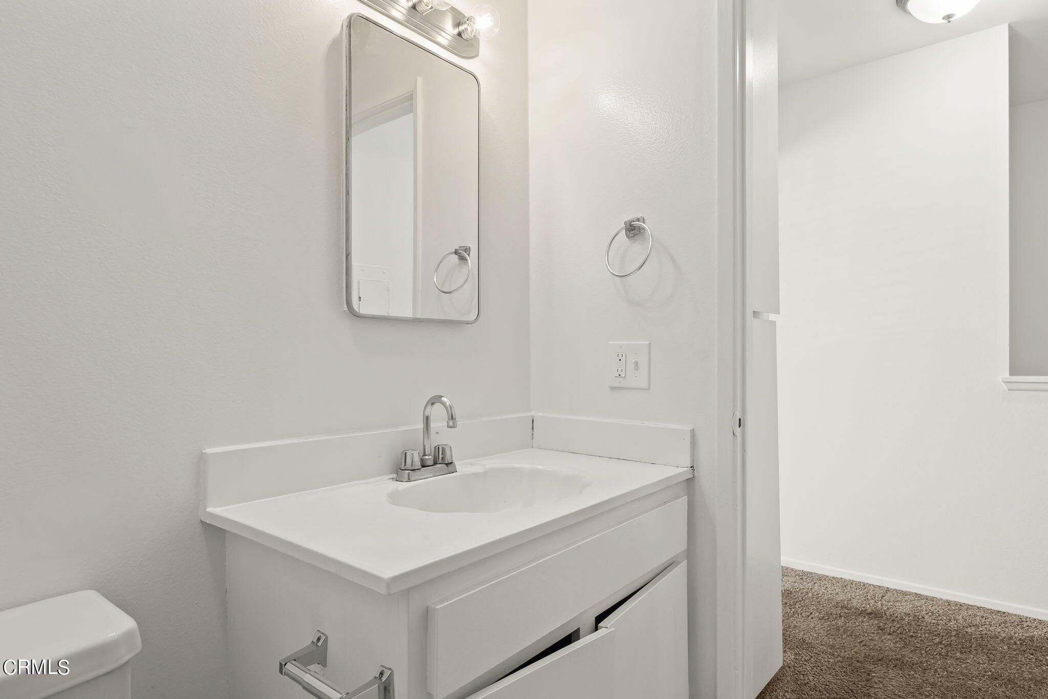 1440 Friedrich Lane, Unit C Oxnard, CA 93033 - Photo 21 of 30 a bathroom with a sink and mirror