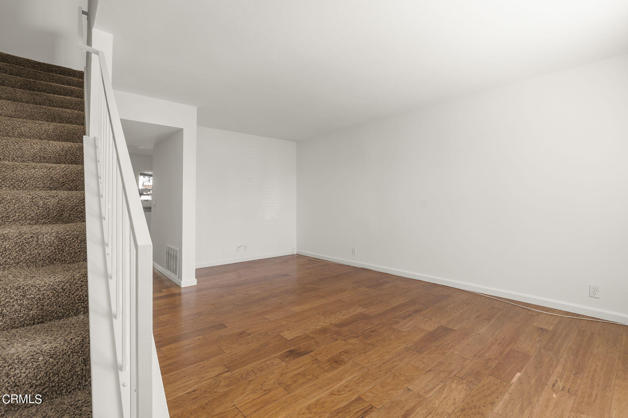 1440 Friedrich Lane, Unit C Oxnard, CA 93033 - Photo 4 of 30 an empty room with wooden floor and entryway