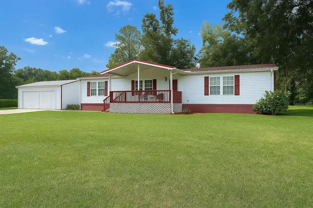 a front view of house with yard and green space
