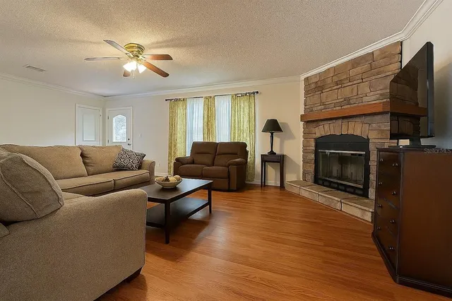 a living room with furniture flat screen tv and a fireplace