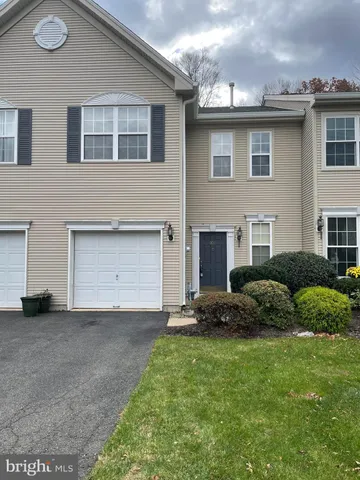 a view of a house with a garden and plants