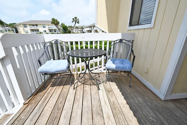 a view of a swimming pool with a yard and trees in the background