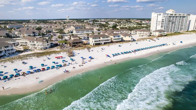 a view of a swimming pool with outdoor seating and city view