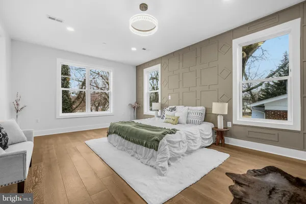 a spacious bedroom with a large bed and a window