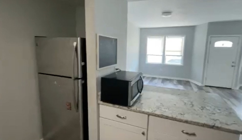 155 Onset Avenue, Unit E Wareham, MA 02558 - Photo 3 of 5 a kitchen with a refrigerator and a sink