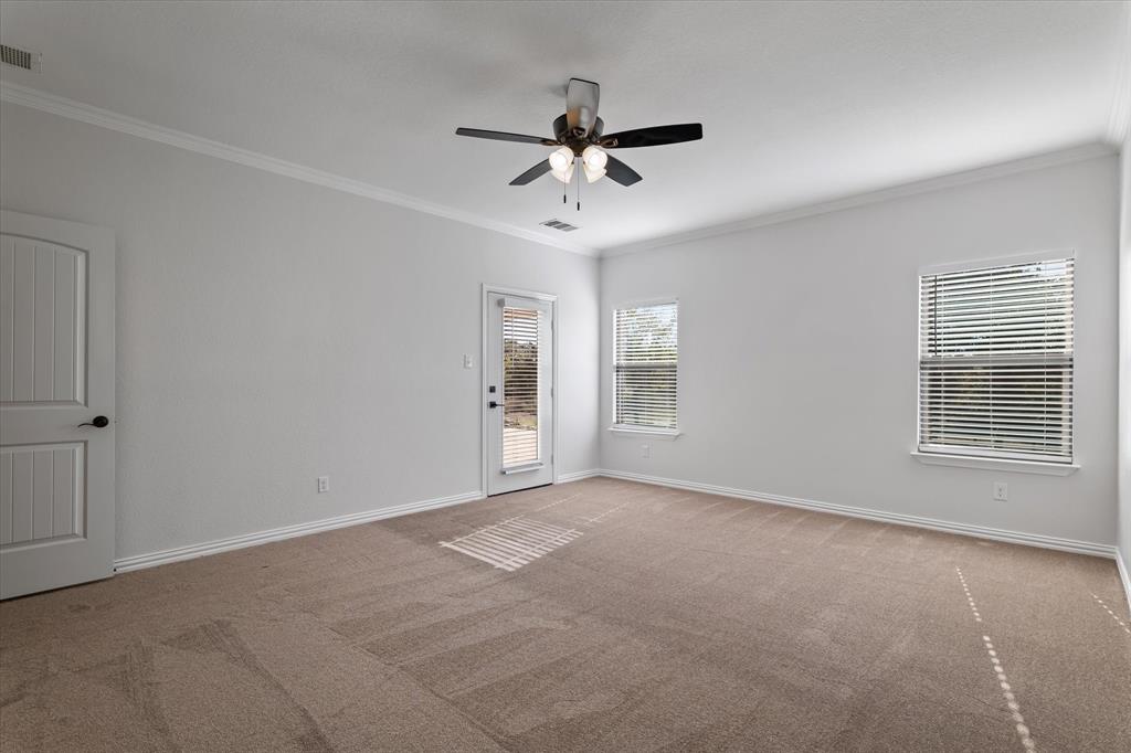 3511 West J E Woody Road Springtown, TX 76082 - Photo 18 of 34 Empty room featuring crown molding, light colored carpet, and ceiling fan