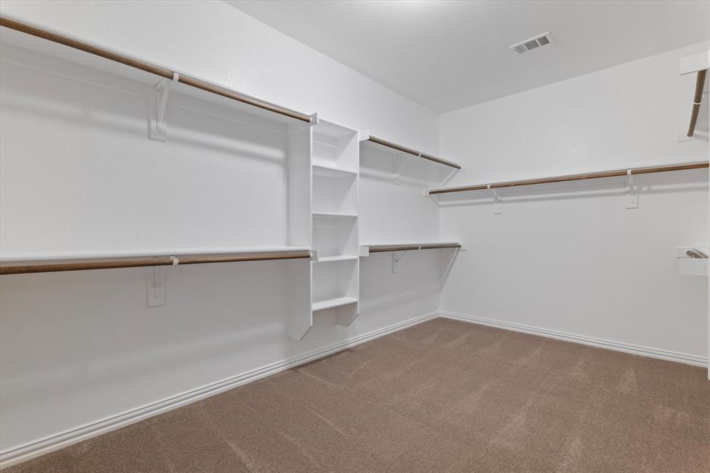 3511 West J E Woody Road Springtown, TX 76082 - Photo 22 of 34 Walk in closet with light colored carpet