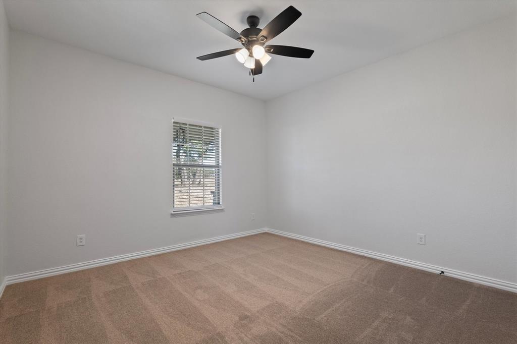 3511 West J E Woody Road Springtown, TX 76082 - Photo 23 of 34 Unfurnished room featuring carpet flooring and a ceiling fan