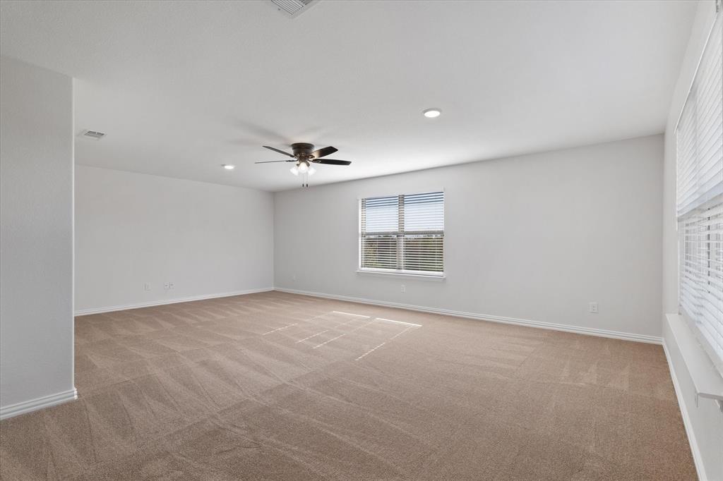 3511 West J E Woody Road Springtown, TX 76082 - Photo 6 of 34 Empty room featuring light carpet, recessed lighting, and a ceiling fan