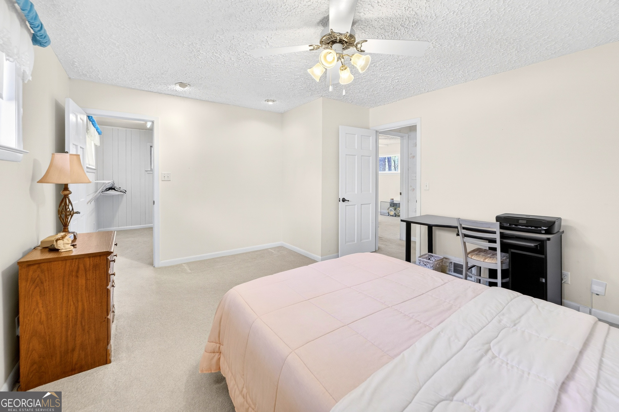 881 Rockbridge Road Southwest Lilburn, GA 30047 - Photo 16 of 44 a bedroom with a bed and a chandelier
