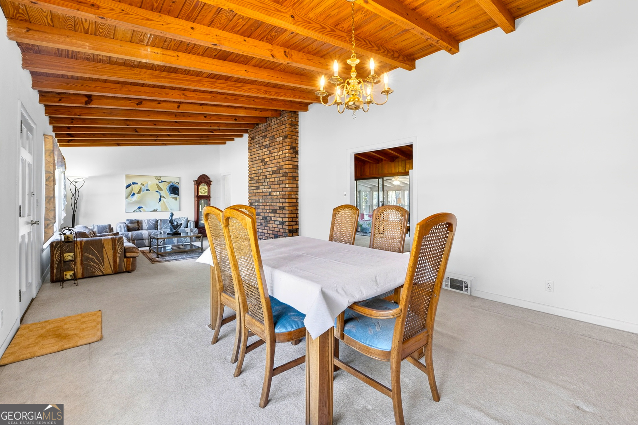 881 Rockbridge Road Southwest Lilburn, GA 30047 - Photo 7 of 44 a dining room with furniture and a chandelier