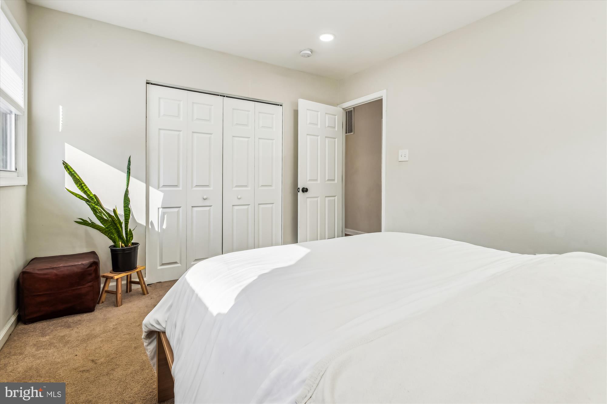 232 Candytuft Road Reisterstown, MD 21136 - Photo 14 of 42 a bedroom with a bed and a potted plant