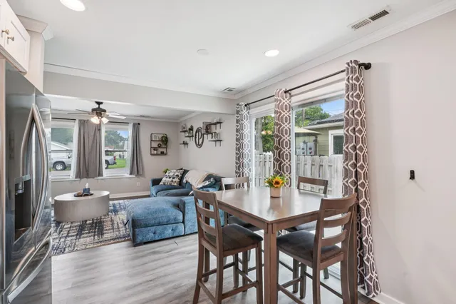 a view of a dining room with furniture window and wooden floor