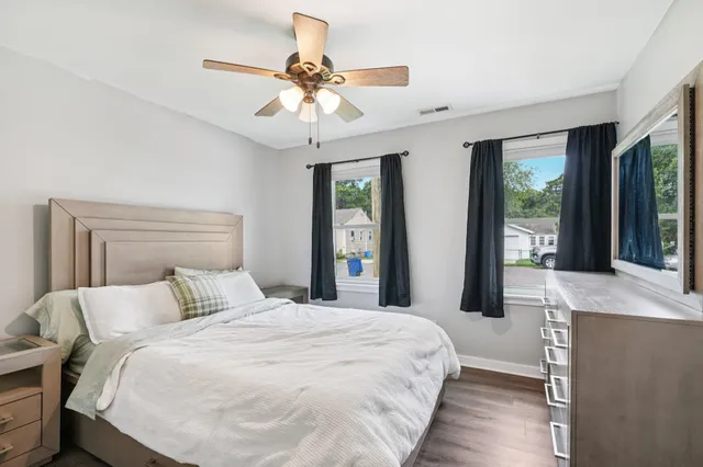 a bedroom with a large bed and a chandelier