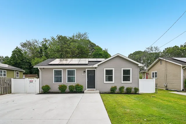 a view of a yard in front view of a house