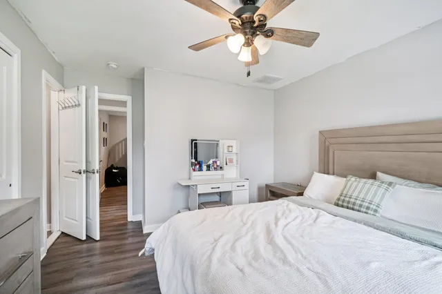 a bedroom with a large bed and a chandelier
