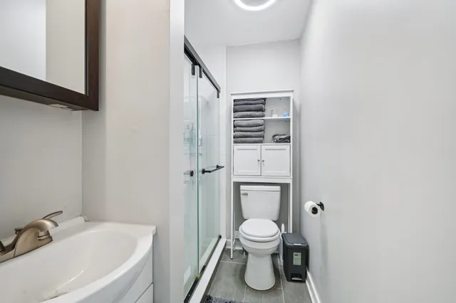 a white toilet sitting next to a bathroom sink