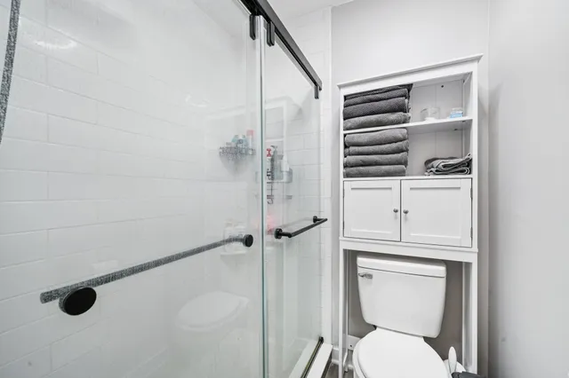 a bathroom with a toilet a sink a vanity and window