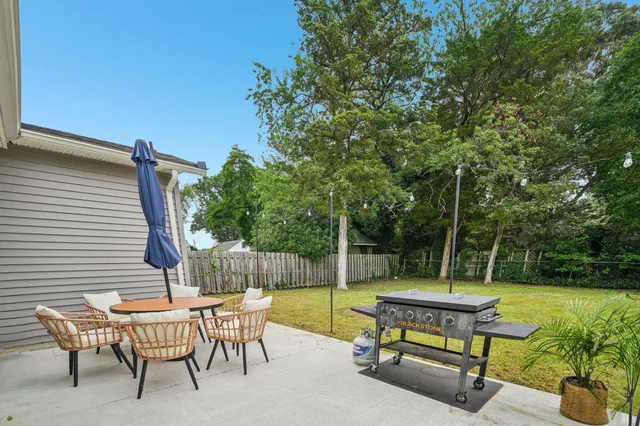 a swimming pool with outdoor seating and garden