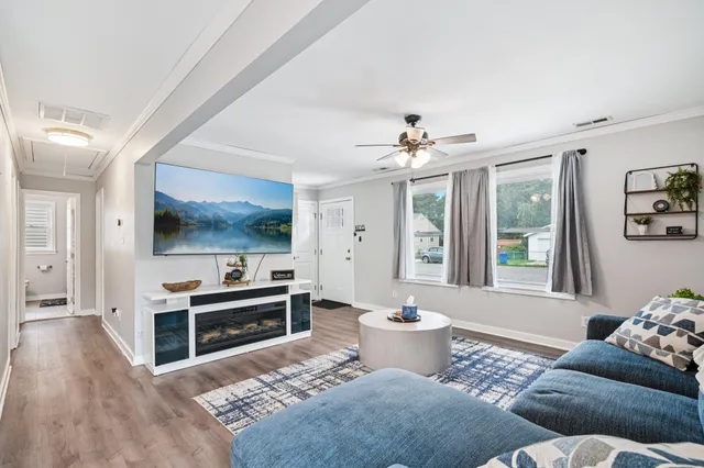 a living room with furniture and a flat screen tv