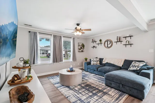 a living room with furniture a window and a table
