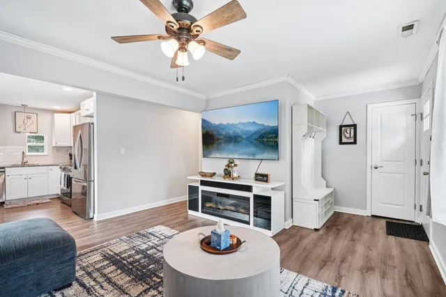 a living room with furniture and a wooden floor