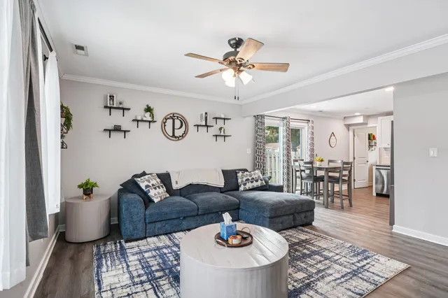 a living room with furniture and wooden floor