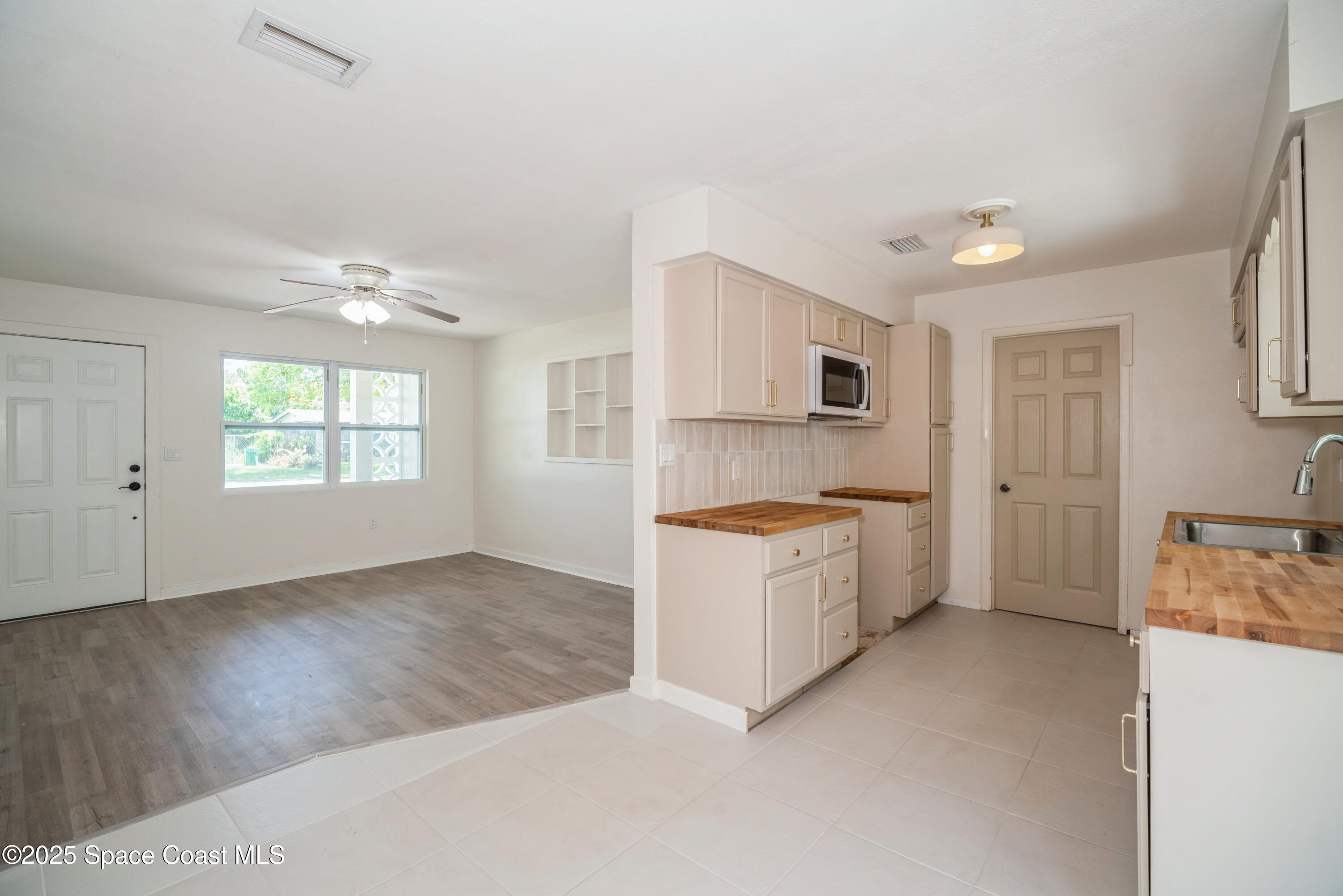 1671 Ollie Street Cocoa, FL 32922 - Photo 5 of 11 a view of a kitchen with a sink dishwasher and a fireplace