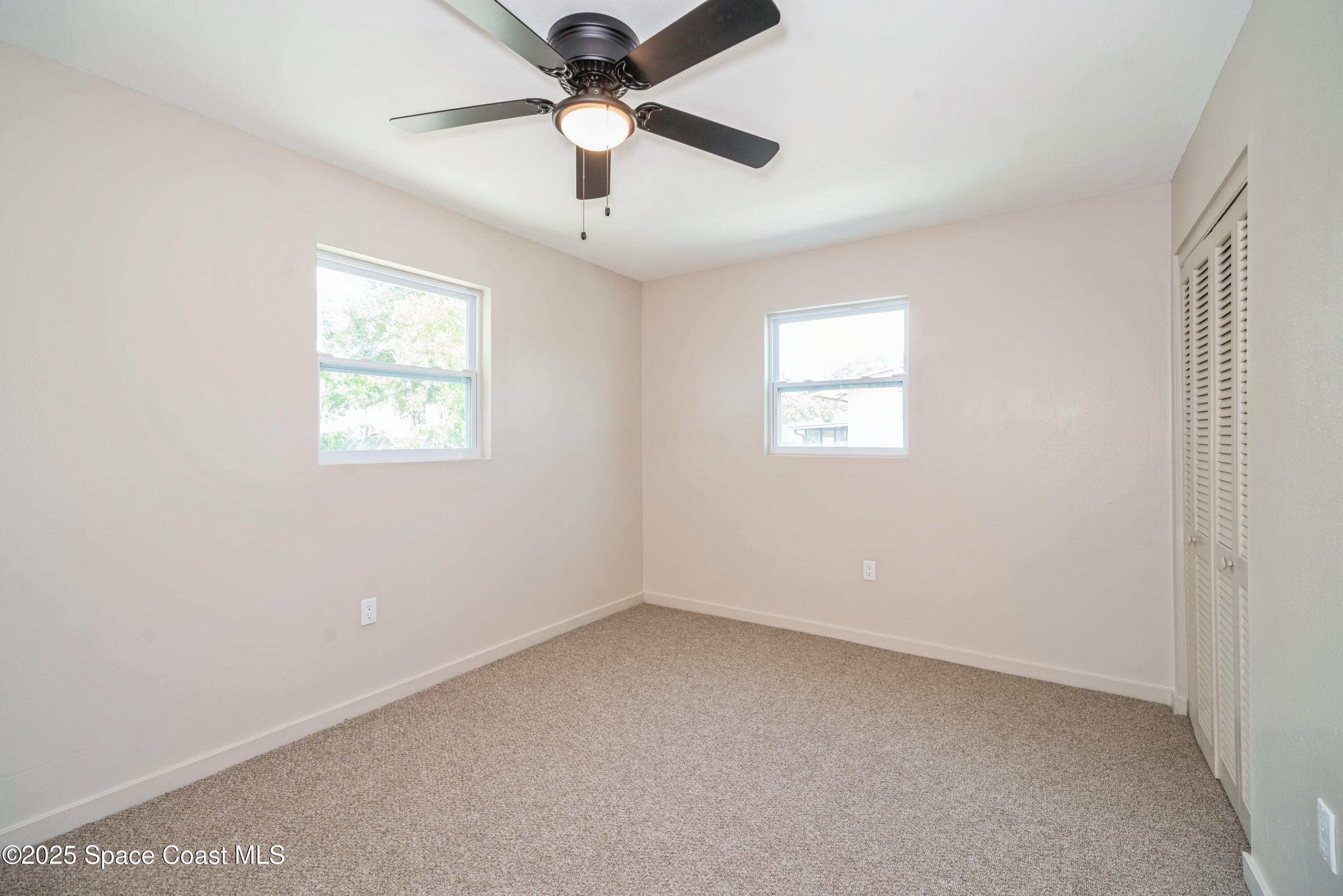 1671 Ollie Street Cocoa, FL 32922 - Photo 6 of 11 an empty room with a window and a fan