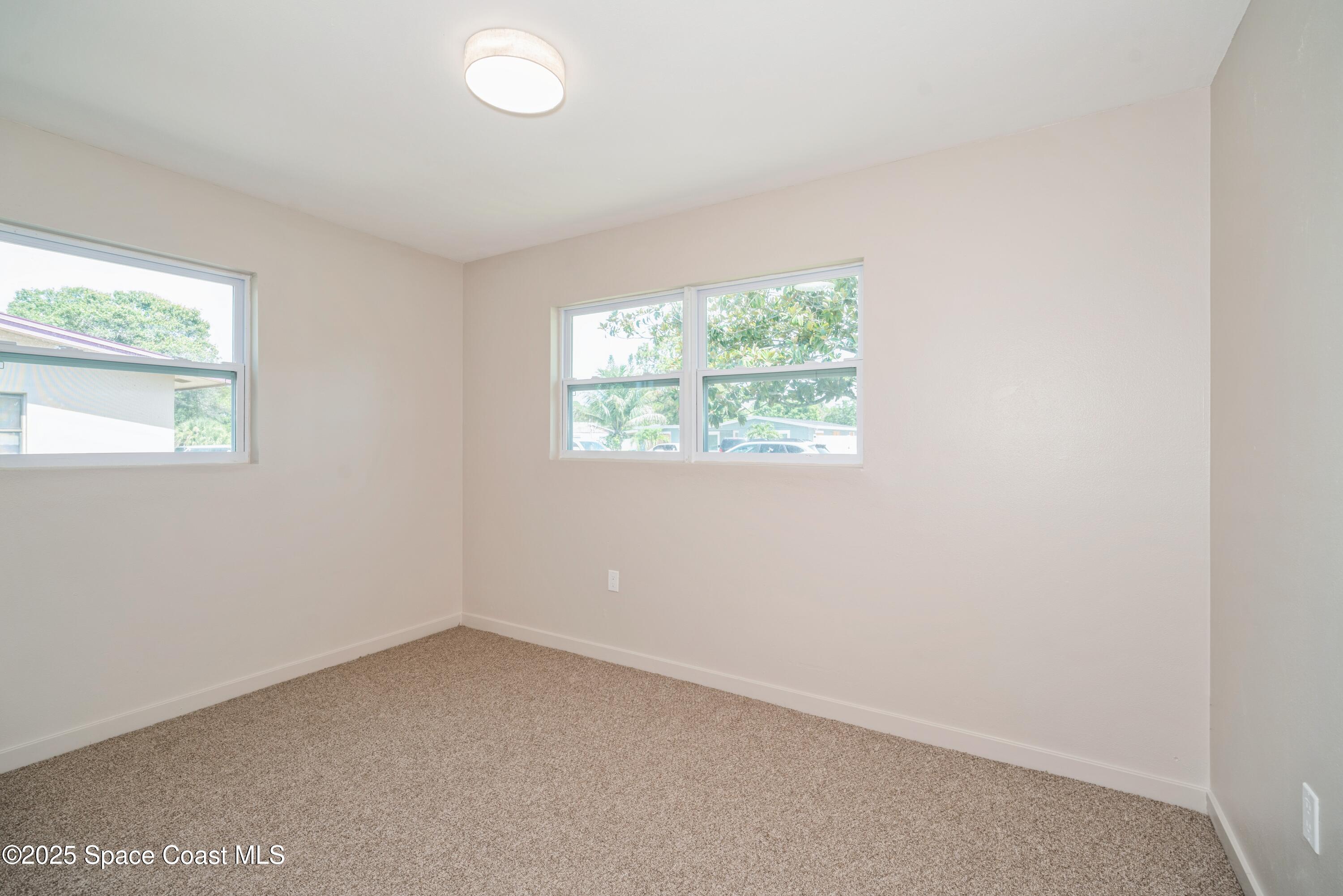 1671 Ollie Street Cocoa, FL 32922 - Photo 8 of 11 an empty room with a window