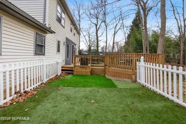 a bedroom with wooden floor and a bed