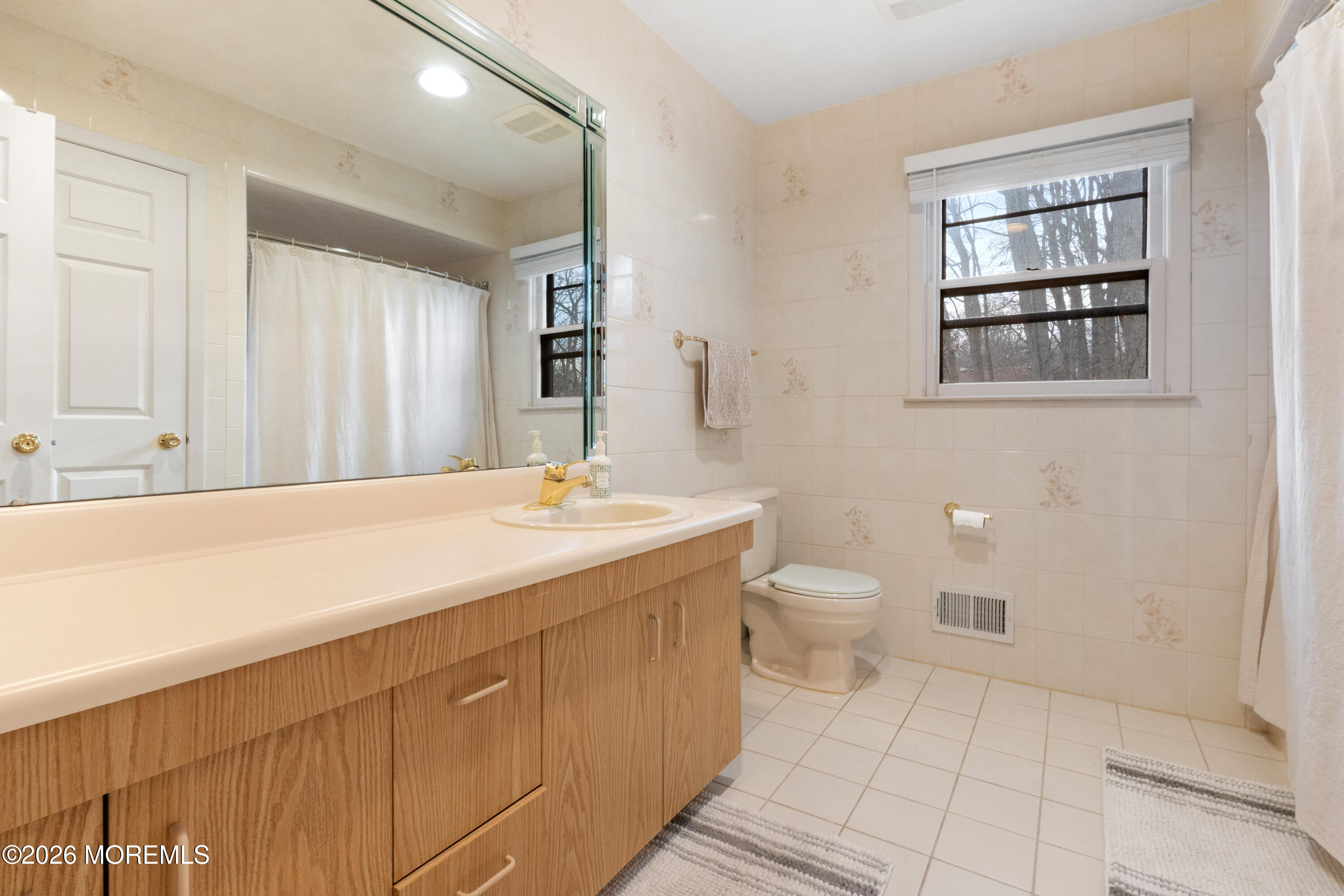 25 Cherokee Road East Brunswick, NJ 08816 - Photo 25 of 34 a spacious bathroom with a toilet sink and mirror
