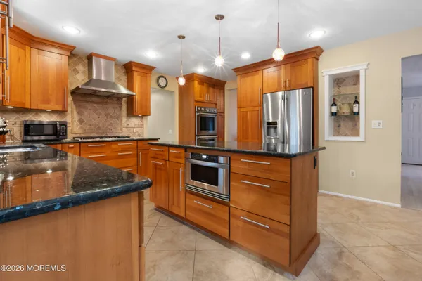 a view of a workspace with furniture and a bookshelf