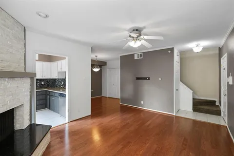 wooden floor in an empty room with kitchen