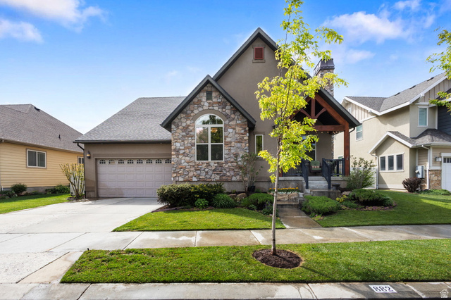882 Sego Lily Way Mapleton, UT 84664 - Photo 1 of 41 Contemporary stucco exterior with stone accents and a covered front porch featuring exposed wood beams