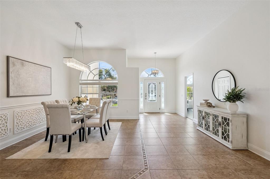 2541 Teton Stone Run Orlando, FL 32828 - Photo 21 of 82 a dining room with furniture a chandelier and window