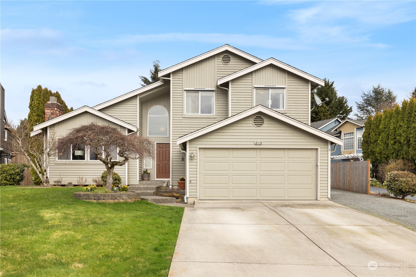 215 237th Place Southwest Bothell, WA 98021 - Photo 1 of 1 a view of a white house next to a yard with big trees