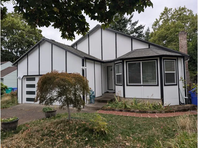 a house that has a tree in front of it