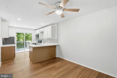 a view of kitchen with sink and wooden floor